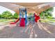 Community playground with slides and other colorful play equipment with a shade structure at 3708 E Bruce Ave, Gilbert, AZ 85234