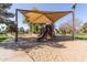 Shaded community playground with slides, climbing structures, and a sand base at 3708 E Bruce Ave, Gilbert, AZ 85234