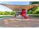 Community playground with a shade structure, slides, and other colorful play equipment for children at 3708 E Bruce Ave, Gilbert, AZ 85234