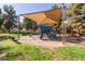 Well-equipped playground with a slide, climbing structures, and shaded seating areas at 3708 E Bruce Ave, Gilbert, AZ 85234