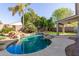 Sparkling pool with rock accents and lush landscaping creates a backyard oasis at 3708 E Bruce Ave, Gilbert, AZ 85234