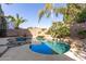 Beautiful backyard pool with a rock waterfall feature and a spacious deck at 3708 E Bruce Ave, Gilbert, AZ 85234