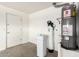 Utility room featuring a water heater, water softener and storage space at 3708 E Bruce Ave, Gilbert, AZ 85234