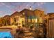 Outdoor living space with a pool, dining area, lush greenery, and cozy seating areas at 3767 W Desert Creek Ln, Phoenix, AZ 85086