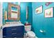 Charming powder room featuring blue walls and vanity with marble countertop and unique mirror at 3767 W Desert Creek Ln, Phoenix, AZ 85086