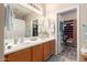 Bathroom with a large mirror, double vanity, and walk in closet in the background at 3767 W Desert Creek Ln, Phoenix, AZ 85086