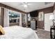 Modern bedroom with a large window, flat-screen TV, and a light and airy feel at 3767 W Desert Creek Ln, Phoenix, AZ 85086