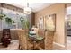 Charming dining area featuring a glass table with wicker chairs and modern artwork on display at 3767 W Desert Creek Ln, Phoenix, AZ 85086