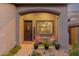 Cozy front porch featuring stylish seating, a decorative wreath, and desert-friendly landscaping at 3767 W Desert Creek Ln, Phoenix, AZ 85086