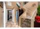 Inviting hallway features tile flooring, a wine refrigerator, and carpeted stairs with safety gate at 3767 W Desert Creek Ln, Phoenix, AZ 85086