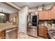 Modern kitchen featuring stainless steel appliances, granite countertops, and a convenient layout at 3767 W Desert Creek Ln, Phoenix, AZ 85086