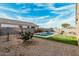 Serene backyard with a sparkling pool, putting green, and easy-care landscaping at 41954 W Plata St, Maricopa, AZ 85138