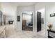 Inviting hallway showcasing tile flooring, with views into the living room and bedroom, offering seamless transitions at 41954 W Plata St, Maricopa, AZ 85138