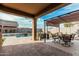 Comfortable covered patio with ample seating and a view of the pool area at 41954 W Plata St, Maricopa, AZ 85138