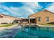 Gorgeous pool with a Baja shelf, two sun umbrellas and desert surroundings at 41954 W Plata St, Maricopa, AZ 85138