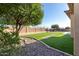 Artificial turf, mature landscaping and a stone path are features of this backyard at 42043 N Bradon Way, Phoenix, AZ 85086