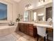 A stylish bathroom featuring dual vanities and a soaking tub at 42043 N Bradon Way, Phoenix, AZ 85086