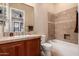 The bathroom features a tile shower and tub with tiled walls, tile counters, and a single sink vanity at 42043 N Bradon Way, Phoenix, AZ 85086