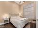 Well-lit bedroom with a ceiling fan, light colored bedding, and a plush seating area at 42043 N Bradon Way, Phoenix, AZ 85086