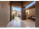 Inviting entryway with stone columns, tile flooring, a bench, and scenic views through an arched gate at 42043 N Bradon Way, Phoenix, AZ 85086