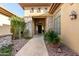 Beautiful home entrance with stone accents, tile walkway, and lush desert landscaping at 42043 N Bradon Way, Phoenix, AZ 85086