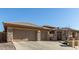 Charming single-story home featuring a desert landscape, a stone facade, and a three-car garage at 42043 N Bradon Way, Phoenix, AZ 85086