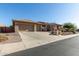 Charming single-story home featuring a desert landscape, a stone facade, and a three-car garage at 42043 N Bradon Way, Phoenix, AZ 85086