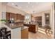 Spacious kitchen with an island, wooden cabinets, and an open layout to the dining area at 42043 N Bradon Way, Phoenix, AZ 85086