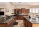 Well-lit kitchen with a large island, stone countertops, and a breakfast bar seating area at 42043 N Bradon Way, Phoenix, AZ 85086