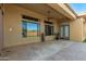 A large, covered patio with tiled floor looks out into the yard from the home's multiple windows and glass doors at 42043 N Bradon Way, Phoenix, AZ 85086