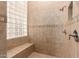 A stylish tiled shower with a built-in bench at 42043 N Bradon Way, Phoenix, AZ 85086