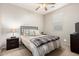 Comfortable bedroom featuring a ceiling fan, a wrought iron bed, and a dresser with a flat screen at 42577 W Rosalia Dr, Maricopa, AZ 85138