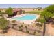 Community pool area featuring lounge chairs, shade structures, and adjacent landscaping at 42577 W Rosalia Dr, Maricopa, AZ 85138