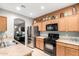 Well-lit kitchen with stainless steel appliances and light wood cabinetry at 42577 W Rosalia Dr, Maricopa, AZ 85138