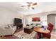 Spacious living room with a ceiling fan, neutral colors, and ample seating at 42577 W Rosalia Dr, Maricopa, AZ 85138