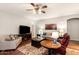 Comfortable living room with plush seating, a ceiling fan, and warm lighting at 42577 W Rosalia Dr, Maricopa, AZ 85138