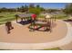 Aerial view of the community playground featuring climbing structures and covered picnic area at 42577 W Rosalia Dr, Maricopa, AZ 85138