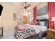 Comfortable bedroom with warm colors, a ceiling fan, and access to the bathroom at 44706 N 10Th Way, New River, AZ 85087