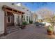 Inviting front patio featuring brick pavers, wrought iron furniture, and a pergola-covered entrance at 44706 N 10Th Way, New River, AZ 85087