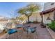 Charming front patio featuring brick pavers, wrought iron furniture, and lush desert landscaping at 44706 N 10Th Way, New River, AZ 85087