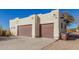 A spacious three-car garage features stylish doors, providing ample parking and storage space at 44706 N 10Th Way, New River, AZ 85087