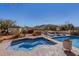 A relaxing hot tub next to a luxurious pool is set against a stunning backdrop of Arizona's natural landscape at 44706 N 10Th Way, New River, AZ 85087