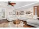 Bright living room with hardwood floors, a large sectional sofa, and decorative accents at 44706 N 10Th Way, New River, AZ 85087