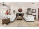 Spacious living room featuring tile flooring, modern furniture, and a stone fireplace at 44706 N 10Th Way, New River, AZ 85087