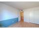 Well-lit bedroom with wood floors, large windows, and a neutral color scheme at 4506 E Arapahoe St, Phoenix, AZ 85044