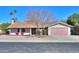 Charming single-story home with a manicured lawn, desert landscaping, and a neatly painted two-car garage at 4506 E Arapahoe St, Phoenix, AZ 85044