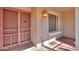 Inviting front entryway featuring a screened front door, classic brickwork, and a charming porch light at 4506 E Arapahoe St, Phoenix, AZ 85044