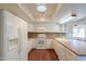 Functional kitchen with white appliances, tiled backsplash, and wood flooring offering ample counter space at 4506 E Arapahoe St, Phoenix, AZ 85044