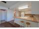 Open kitchen featuring counter seating, white cabinetry and stainless steel appliances at 4506 E Arapahoe St, Phoenix, AZ 85044