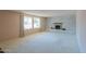 Bright living room with a large window, neutral carpet, and a classic brick fireplace as a focal point at 4506 E Arapahoe St, Phoenix, AZ 85044